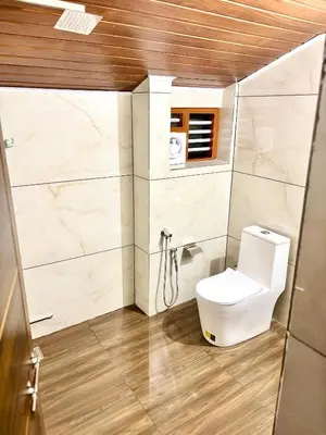 a bathroom with a toilet in a room at KODIYADAN s INN A Homestay with a Heart in Meenangadi