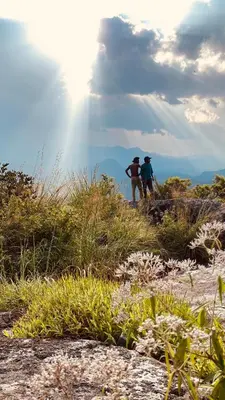 two people standing on top of a hill at Wayanad Camping in Ambalavayal