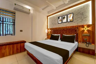 a bedroom with a large bed in a room at Super Townhouse Cochin Airport Formerly Skyluxe in Cochin