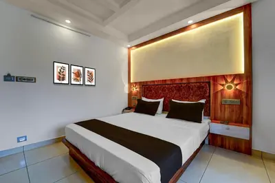 a bedroom with a large bed in a room at Super Townhouse Cochin Airport Formerly Skyluxe in Cochin