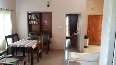 a room with a table and chairs and a dining room at Mulberry Bay Serviced Apartments in Mysore