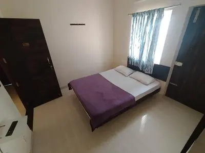 a small bedroom with a bed and a window at Union Rooms in Coimbatore