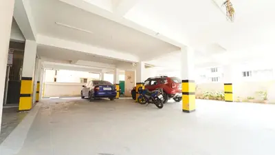 a garage with cars and motorcycles parked in it at Union Rooms in Coimbatore