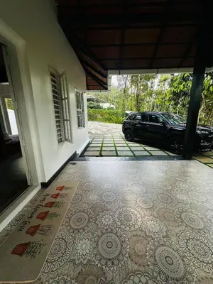 an entrance to a house with a tile floor at ThunderHill by Casablanca - A Premium Pool Villa in Meenangadi