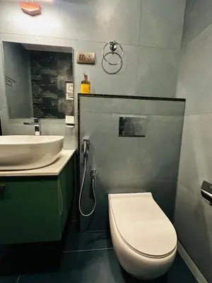 a bathroom with a toilet and a sink at ThunderHill by Casablanca - A Premium Pool Villa in Meenangadi