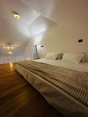 a large white bed in a room with aamed ceilings at ThunderHill by Casablanca - A Premium Pool Villa in Meenangadi
