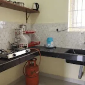 a kitchen with a fire hydrant on the counter at Sai Home Stay in Marudhamalai