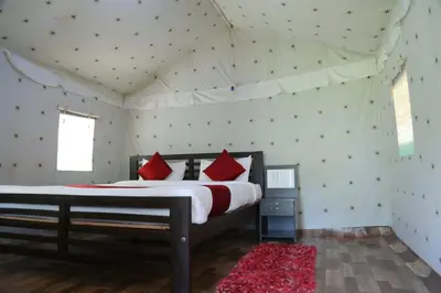 a bedroom with a large bed in a tent at Hotel green land in Madikeri