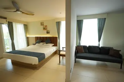 a bedroom with a bed and a couch at Nine, Boutique hotel with luxury room stay, mysore in Mysore