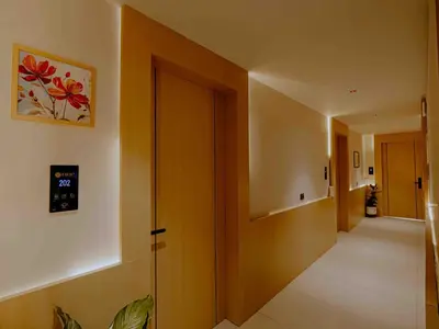 a hallway with a door and a clock on the wall at Nine, Boutique hotel with luxury room stay, mysore in Mysore