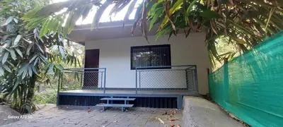 a blue bench sitting on the porch of a house at Hill valley farm resort in Viripara
