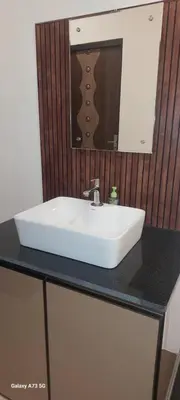 a white sink on a black counter in a bathroom at Hill valley farm resort in Viripara