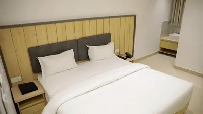 a large white bed with two pillows in a room at Vanaalayam Retreat Palladam By Arcadia in Palladam