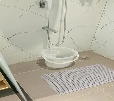 a shower with a bowl in the corner of a bathroom at Vanaalayam Retreat Palladam By Arcadia in Palladam