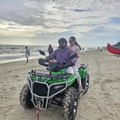a man and woman riding a quad bike on the beach at Dream nest beach house Resort with private beach entrance in Trichūr