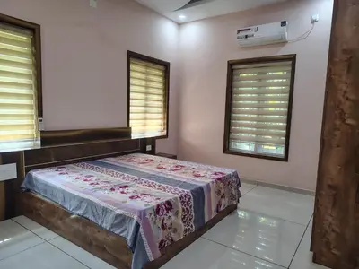 a bedroom with a bed and two windows at Oriyon villa in Kāladi
