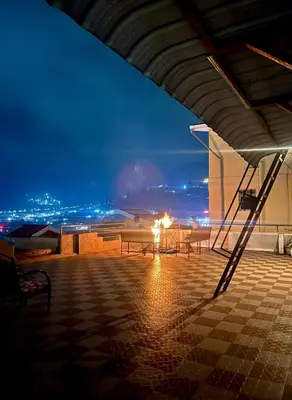 a group of benches on top of a building at night at Coolspot Cottage in Ooty