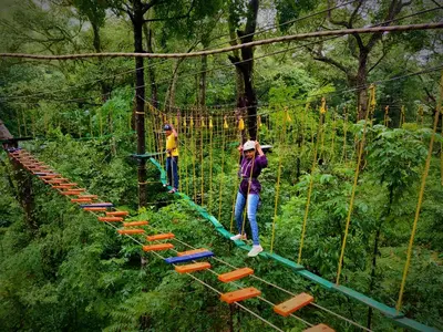 two people on a rope bridge in the forest at Coorg Mystere Luxury Home Stay in Madikeri
