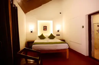 a small bedroom with a bed in a room at Coorg Mystere Luxury Home Stay in Madikeri
