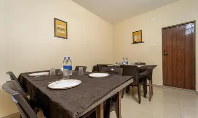 a dining room with tables and chairs with bottles of water at Itsy Hotels Everest Leela Residency in Erode