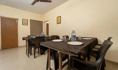 a dining room with a table and black chairs at Itsy Hotels Everest Leela Residency in Erode