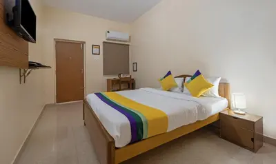 a bedroom with a large bed with a colorful blanket at Itsy Hotels Everest Leela Residency in Erode