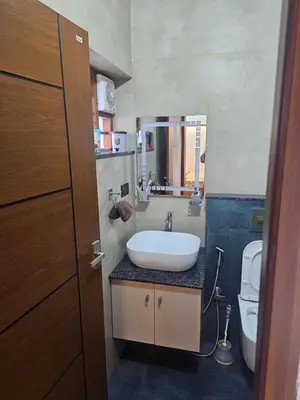 a bathroom with a sink and a toilet at Dreams Premium Villa in Kozhikode