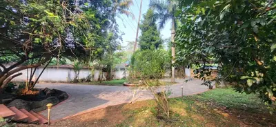 a garden with a path and trees and a pond at Periyar Heritage in Kotamangalam