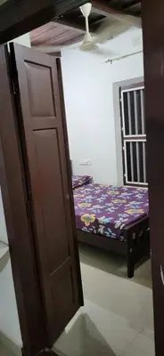 a open door to a bedroom with a bed at Periyar Heritage in Kotamangalam
