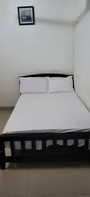 a bed in a room with a white mattress at Periyar Heritage in Kotamangalam
