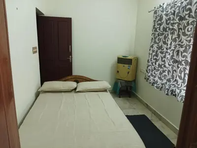 a small bedroom with a bed in a room at Shield Guest Accommodation in Pudunagaram