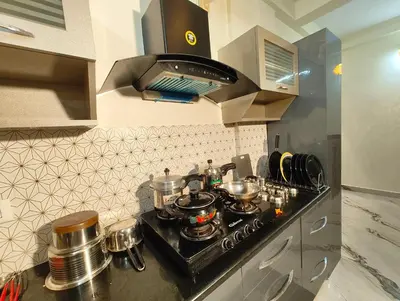 a kitchen with a stove with pots and pans at Casa de Shalom - 3 Bedroom AC Villa 65
