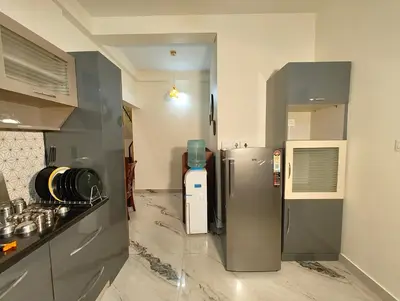 a kitchen with a refrigerator in the middle of a room at Casa de Shalom - 3 Bedroom AC Villa 65