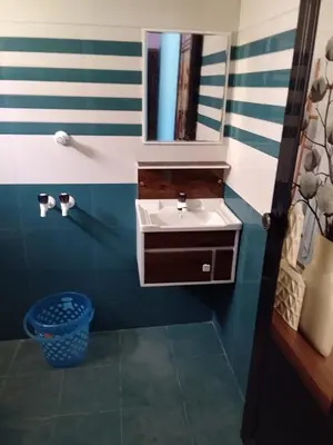 a bathroom with a sink and a mirror at Tharissu potta farm stay in Kollengode