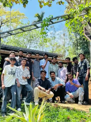 a group of people posing for a picture at Woodshade resort in Wayanad