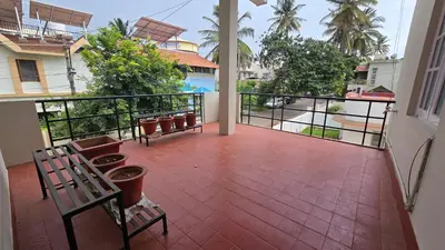 a balcony with benches and a view of the street at The Horalahalli House in Mysore