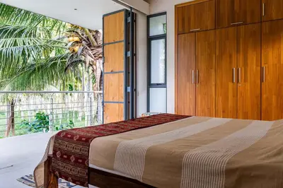 a bedroom with a bed and a large window at Spacious 3BR Daveys Townhouse with Private Lawn Pet Friendly and Complimentary Breakfast in Mysore