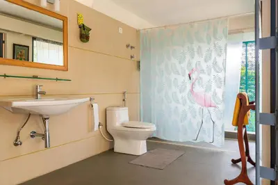a bathroom with a toilet and a sink at Spacious 3BR Daveys Townhouse with Private Lawn Pet Friendly and Complimentary Breakfast in Mysore