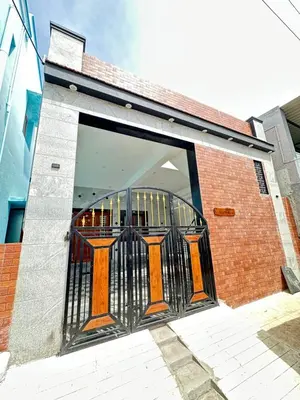 an entrance to a building with an orange door at Bhargavi homes in Coimbatore