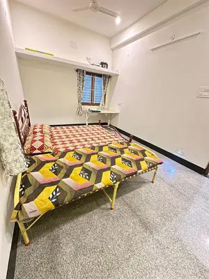 a bedroom with a bed in a room at Bhargavi homes in Coimbatore