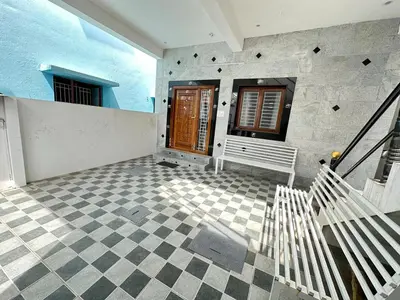 a porch with a bench and a wooden door at Bhargavi homes in Coimbatore
