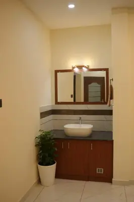 a bathroom with a sink and a mirror at Joen homes apartment in Alwaye
