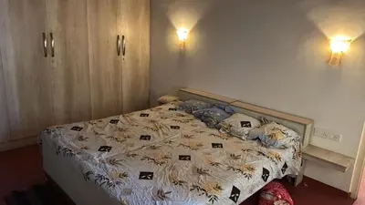 a bedroom with a bed with a comforter on it at Cityscape Residence and Homestay Tirupur in Tiruppūr