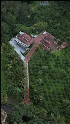 an aerial view of a house in a forest at Midnight Oasis Wayanad in Meenangadi