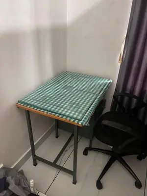 a table and a chair in a room at Midnight Oasis Wayanad in Meenangadi