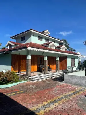 a house with a patio in front of it at Midnight Oasis Wayanad in Meenangadi