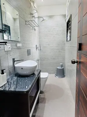 a bathroom with a sink and a toilet at CLR Homestay & Villa in Kushālnagar