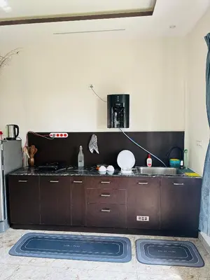 a kitchen with a sink and a counter top at CLR Homestay & Villa in Kushālnagar