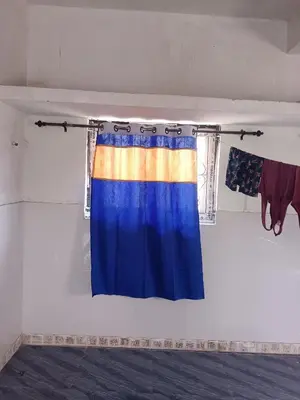 a curtain hanging on a wall in a room at Sona rooms in Coimbatore