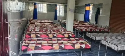 a row of beds in a room at Sona rooms in Coimbatore